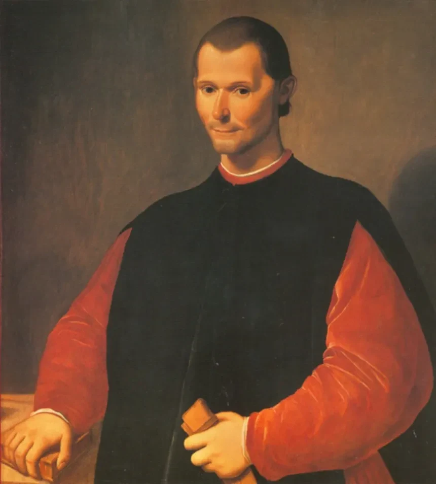 Portrait of Niccolò Machiavelli in a black robe over red sleeves, holding a small book, with a faint closed-mouth smile